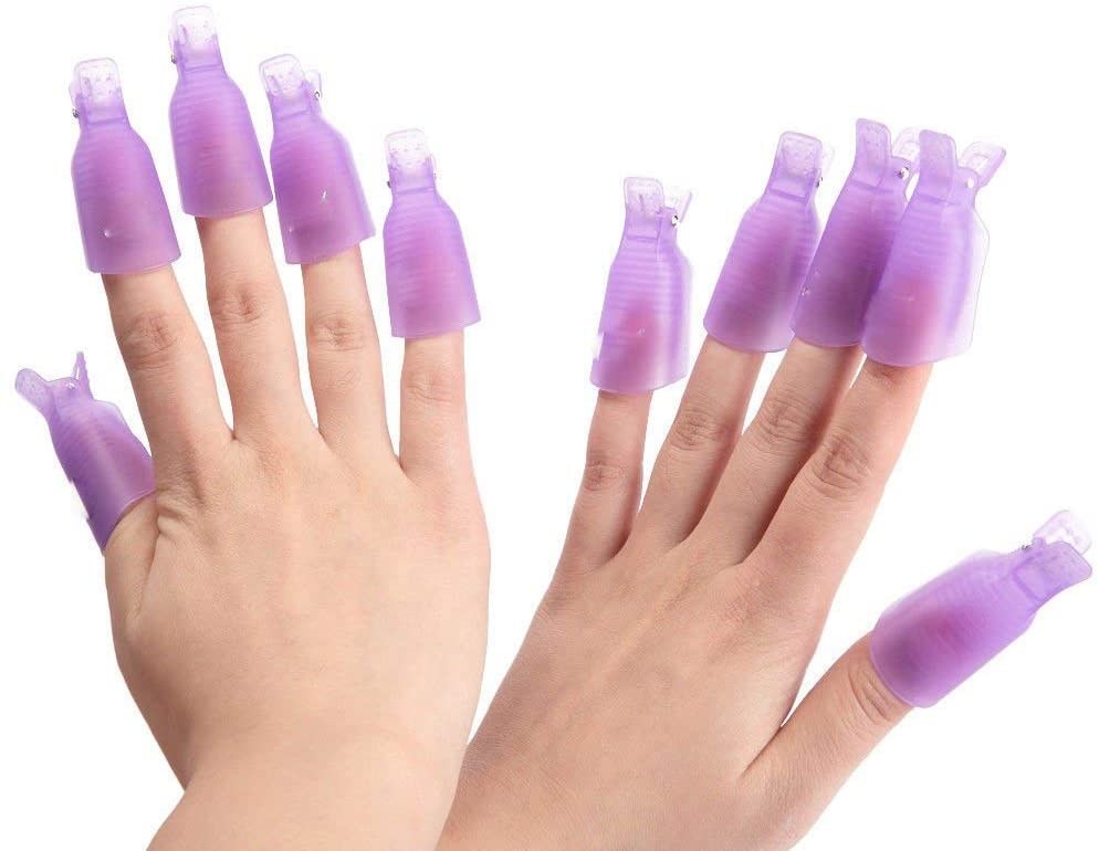 A person wearing plastic clips over their fingers