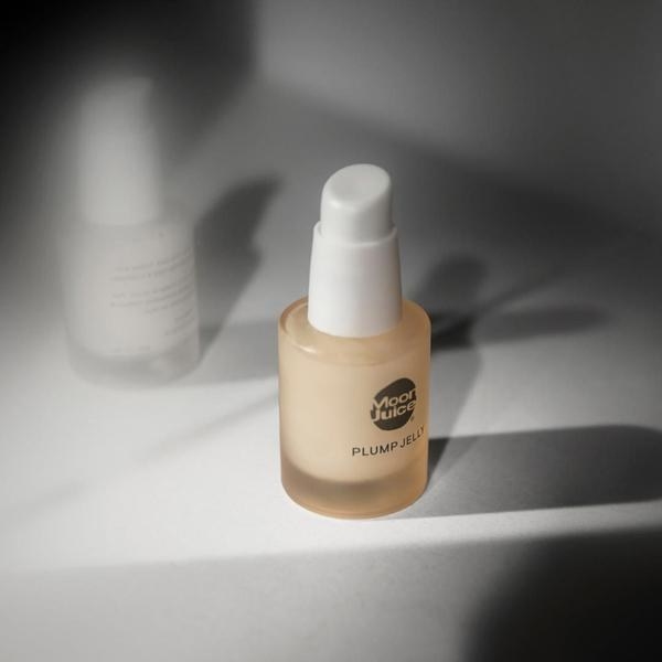 a rounded tan glass bottle with a white pump