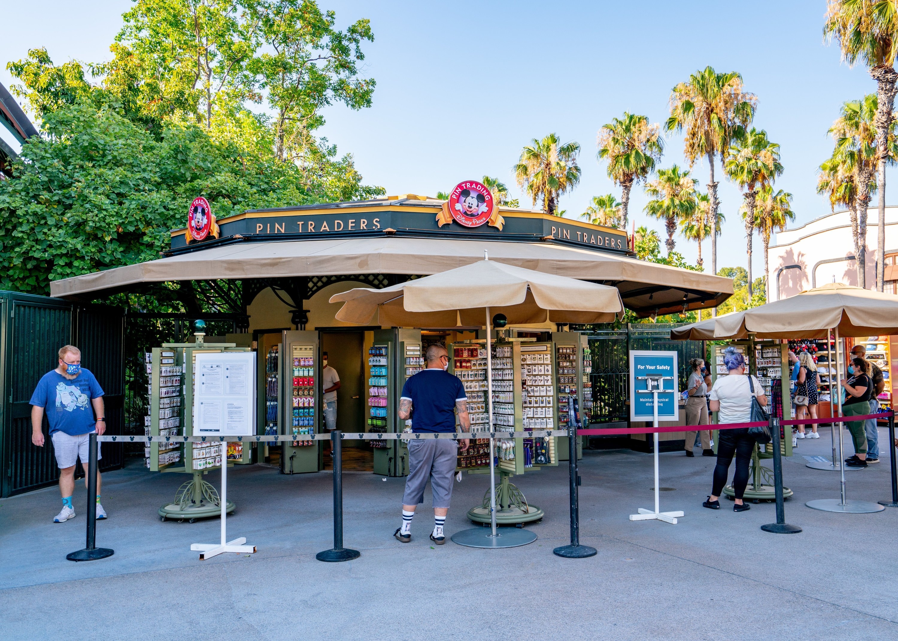 Visitors stand six feet apart on the Disney Downtown District promenade