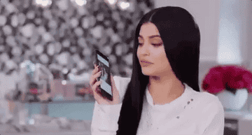 A person kissing their phone