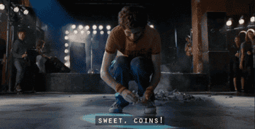 Scott Pilgrim collecting change from the ground, exclaiming, &quot;Sweet, coins!&quot;