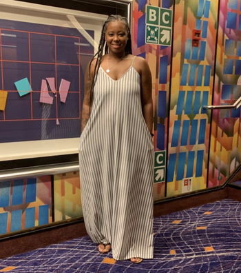 reviewer wearing gray and white striped tank dress