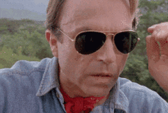 Sam Neil as Dr. Alan Grant, taking off his glasses in &quot;Jurassic Park&quot;