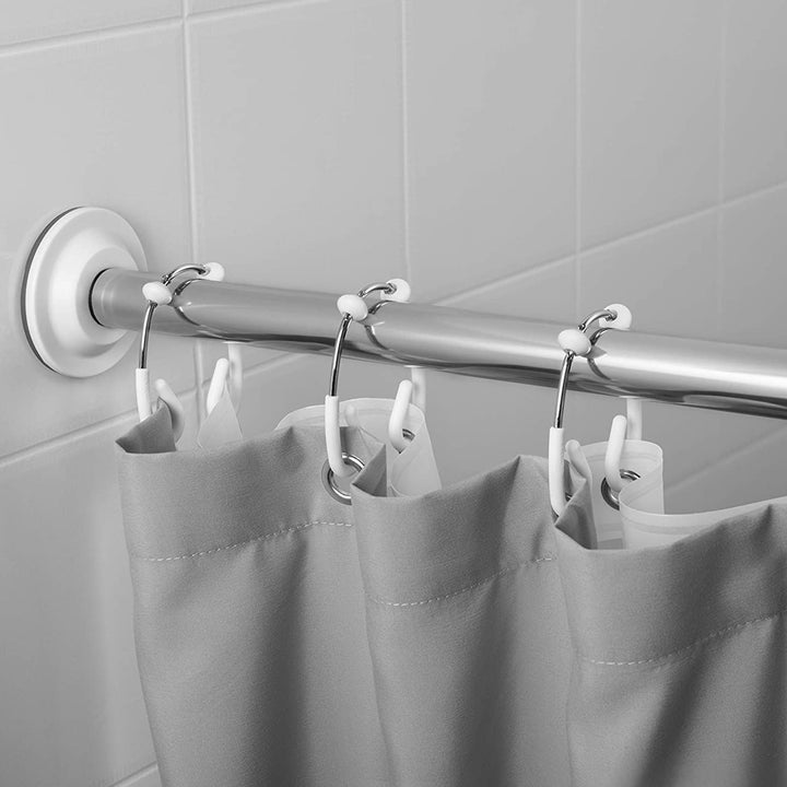 Two shower curtains hung on the hooks and arranged on a rod