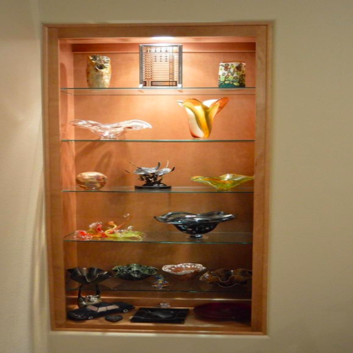 A customer review photo of a glass shelf with multiple glass objects secured with the Museum Gel