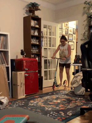 buzzfeed editor riding the scooter in her apartment