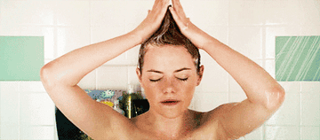 emma stone in &quot;easy a&quot; singing in the shower and sweeping her shampooed hair into a mohawk
