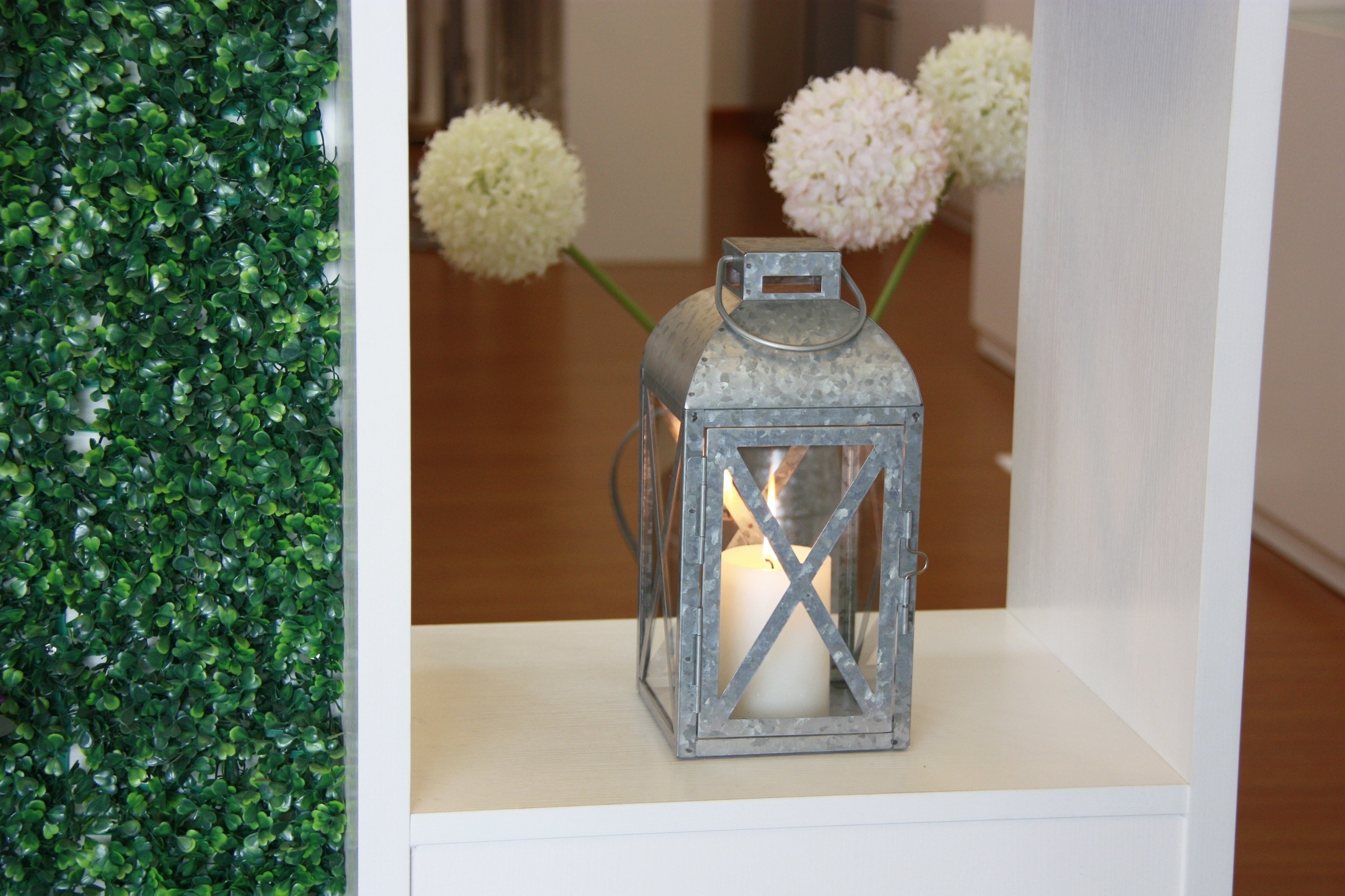 a metal silver candle holder that looks like a lantern