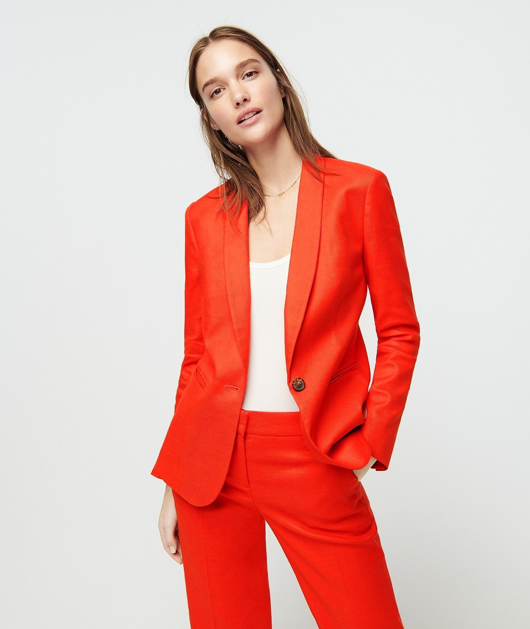 model in bright red single button blazer with matching pants