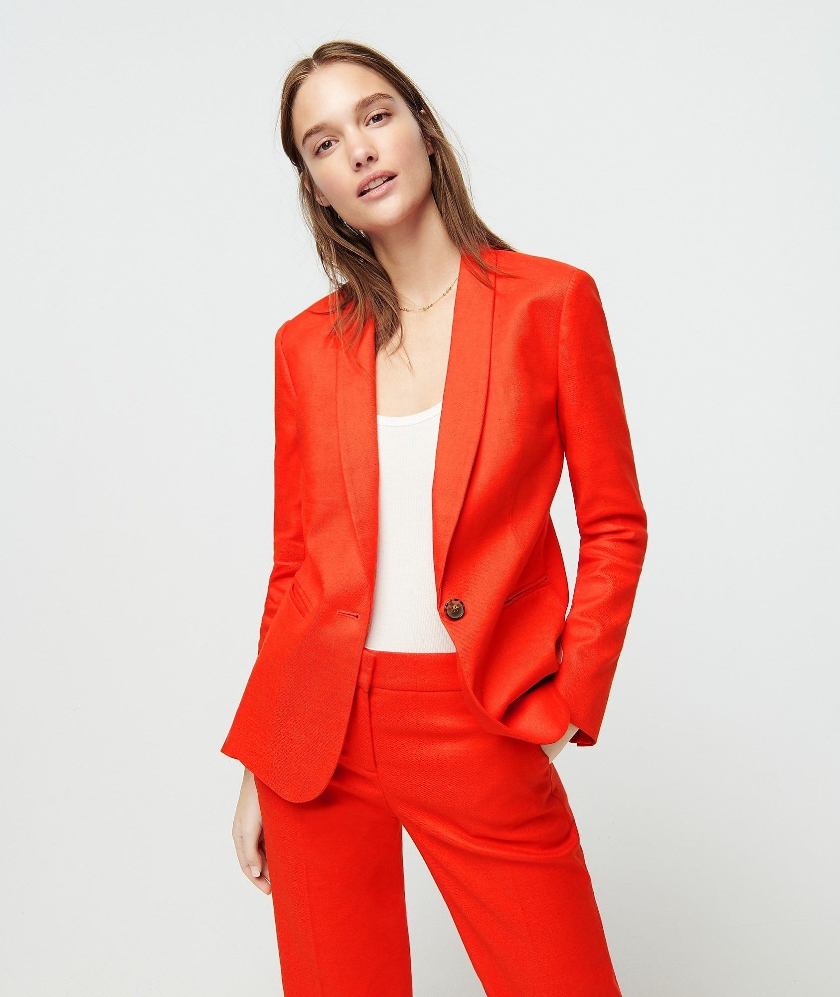 model in bright red single button blazer with matching pants