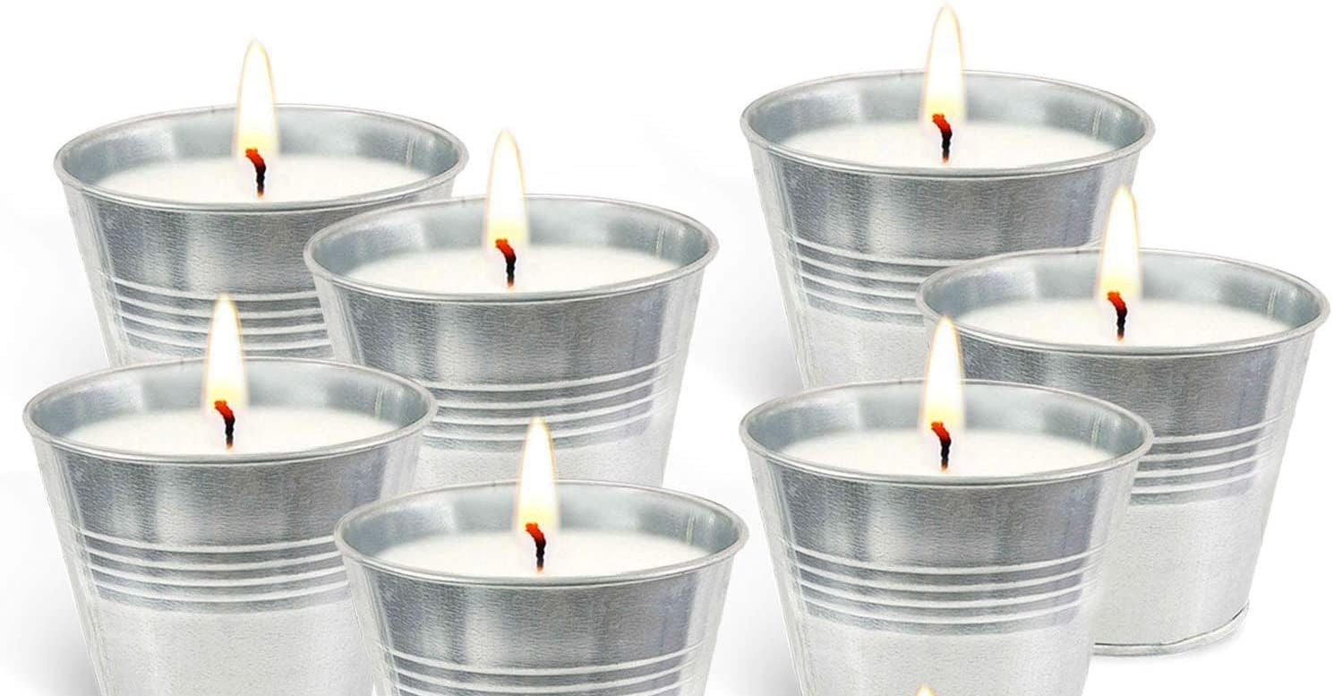 Candles in buckets with their wick lit