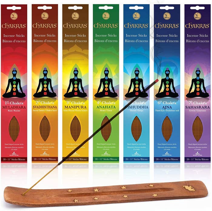 Seven packs of incense and a stick in an incense burner