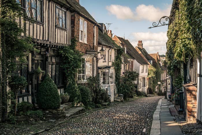 Cobbled streets with houses either side on a sunny but cloudy day