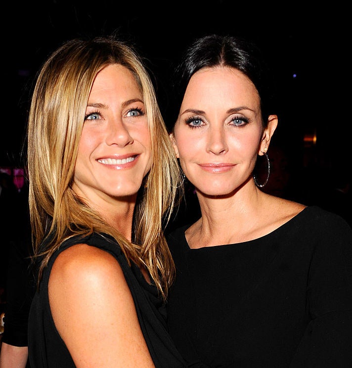 Photo of Jennifer Aniston hugging Courteney Cox at an event in 2010