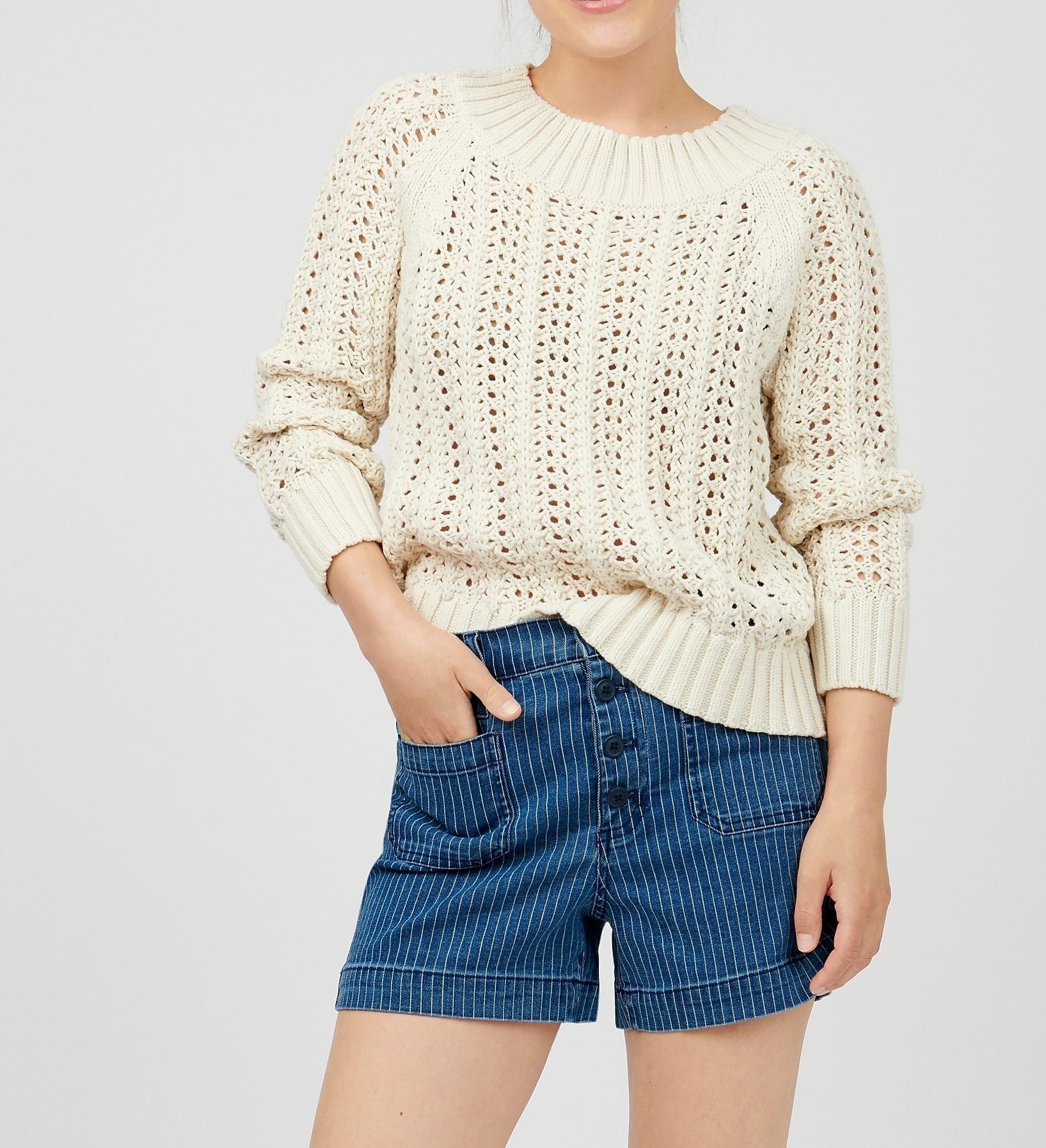 model in beige sweater with wide ribbed hem, neck, and cuffs