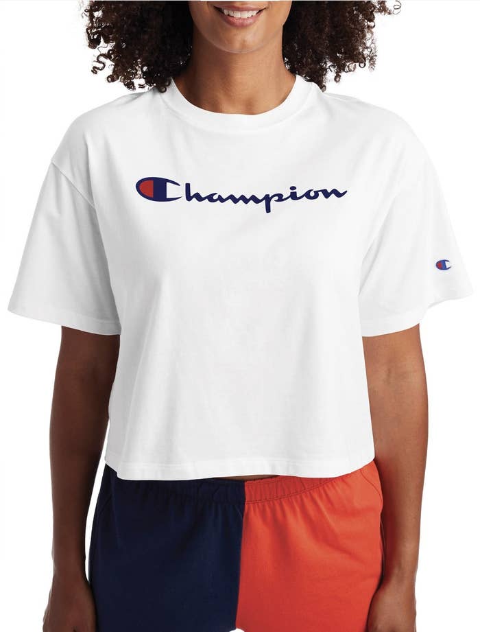Model in the white T-shirt with Champion written across the chest