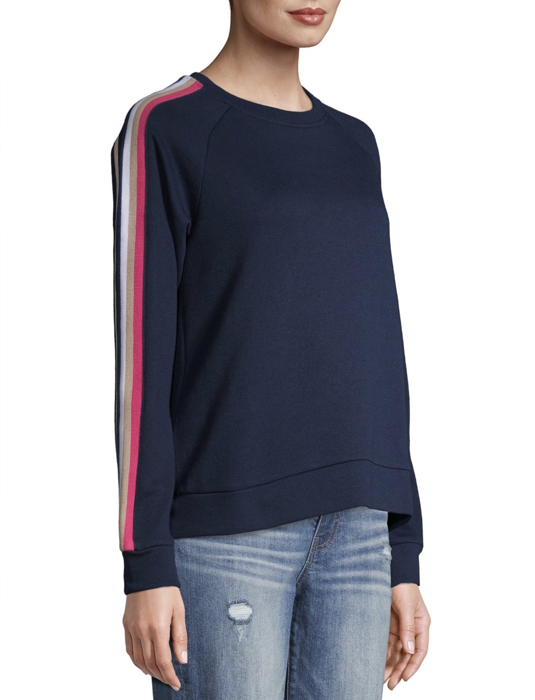 Model in navy blue sweatshirt with red sleeve stripes