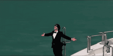 Andy Samberg in the music video for &quot;I&#x27;m on a boat&quot; standing on the front of a yacht in a tuxedo