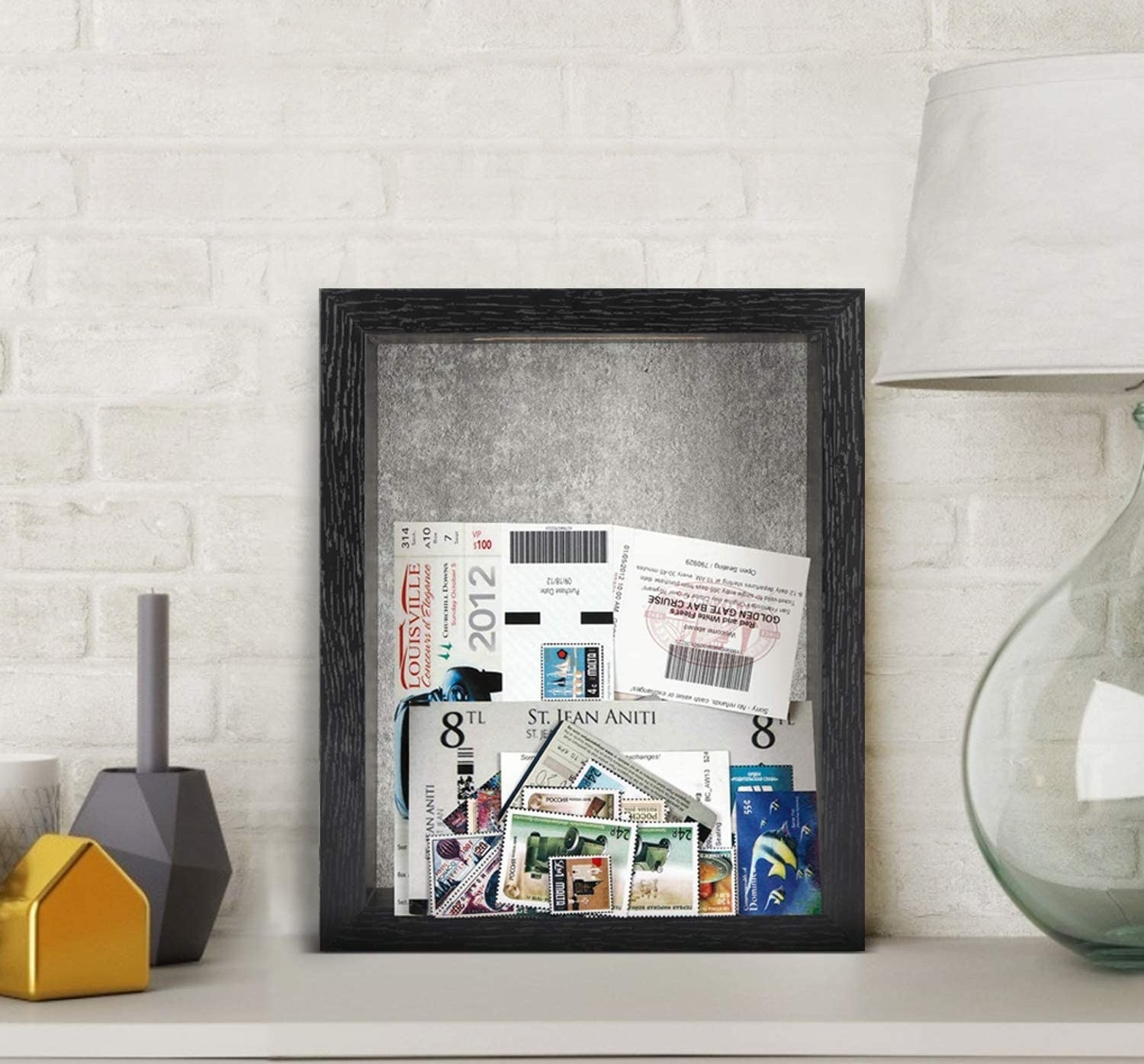 The shadow box perched on a sideboard and filled with ticket stubs and photographs