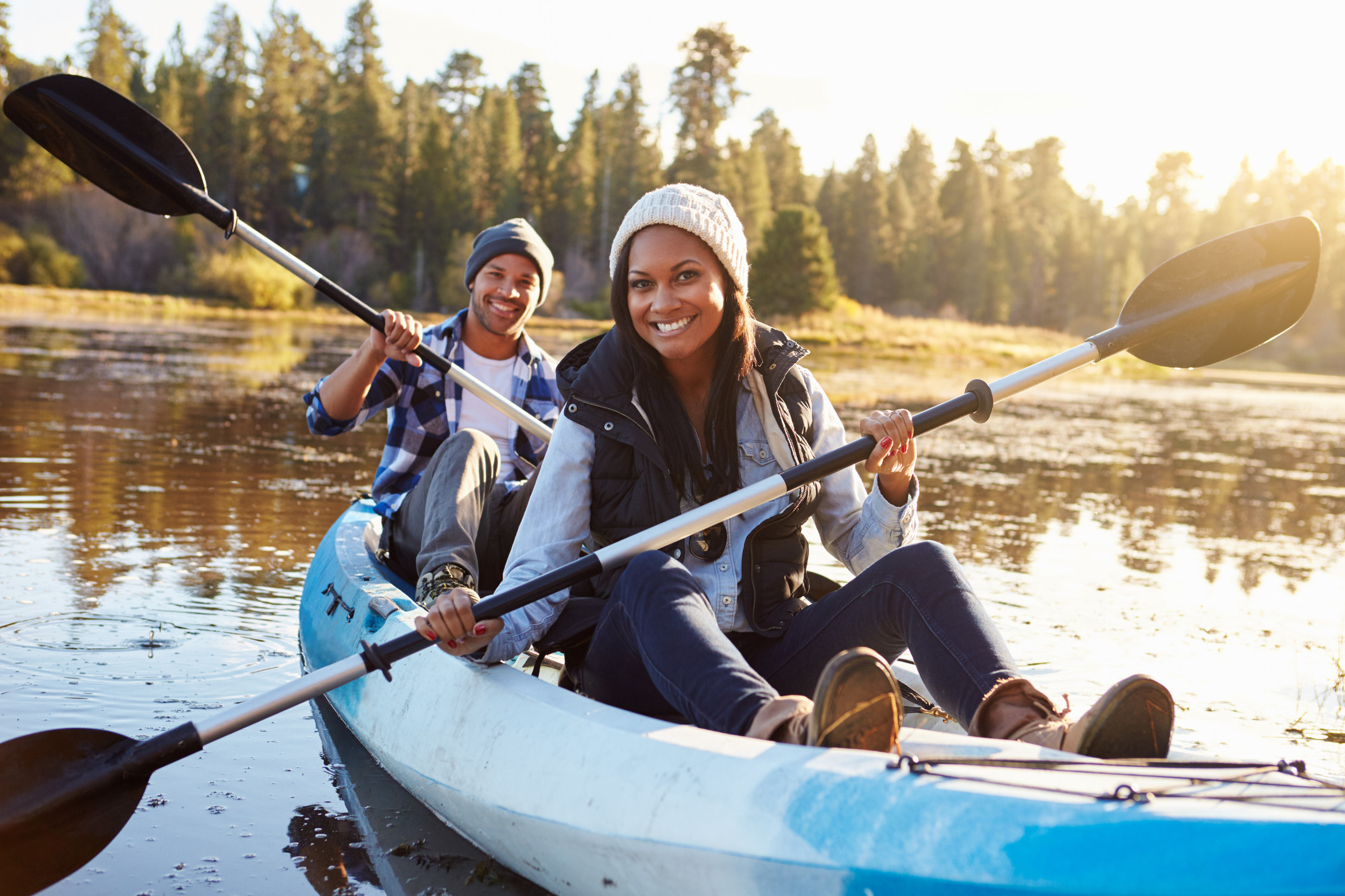 Smiling couple, man and woman, kayaking.