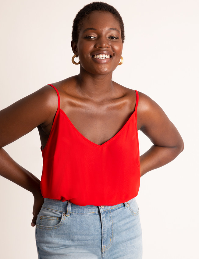 Model wearing the spaghetti-strap tank in bright red