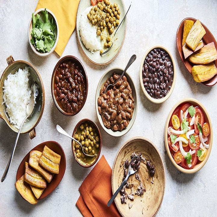 A dinner laid out on a table including A Dozen Cousins ready to eat seasoned beans.