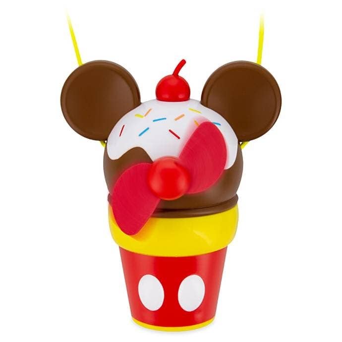 The fan, which has blades on what looks like a scoop of ice cream with Mickey ears and a cherry top in a cup printed with the design of Mickey&#x27;s pants