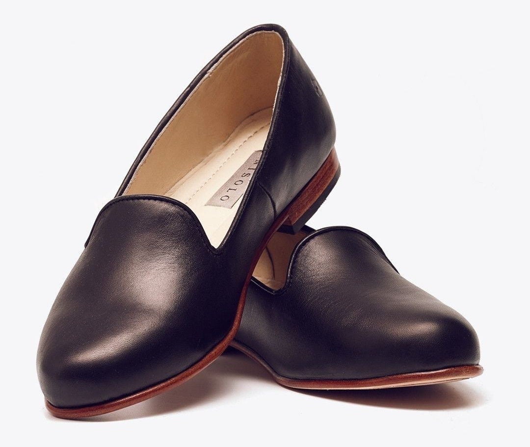pair of black leather smoking slipper flats with rich brown bases