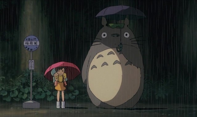 Mei and Satsuki waiting for the bus with Totoro