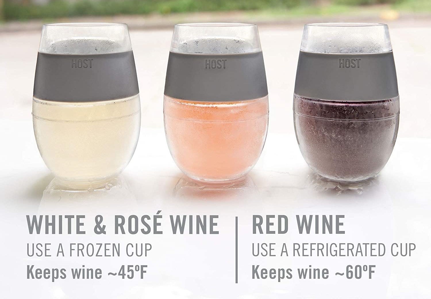 Three frosty glasses have white rosé and red wine in them