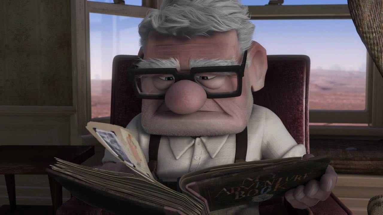 Carl looking through the adventure book full of photos