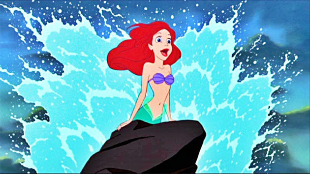Ariel singing on a rock with waves splashing around her