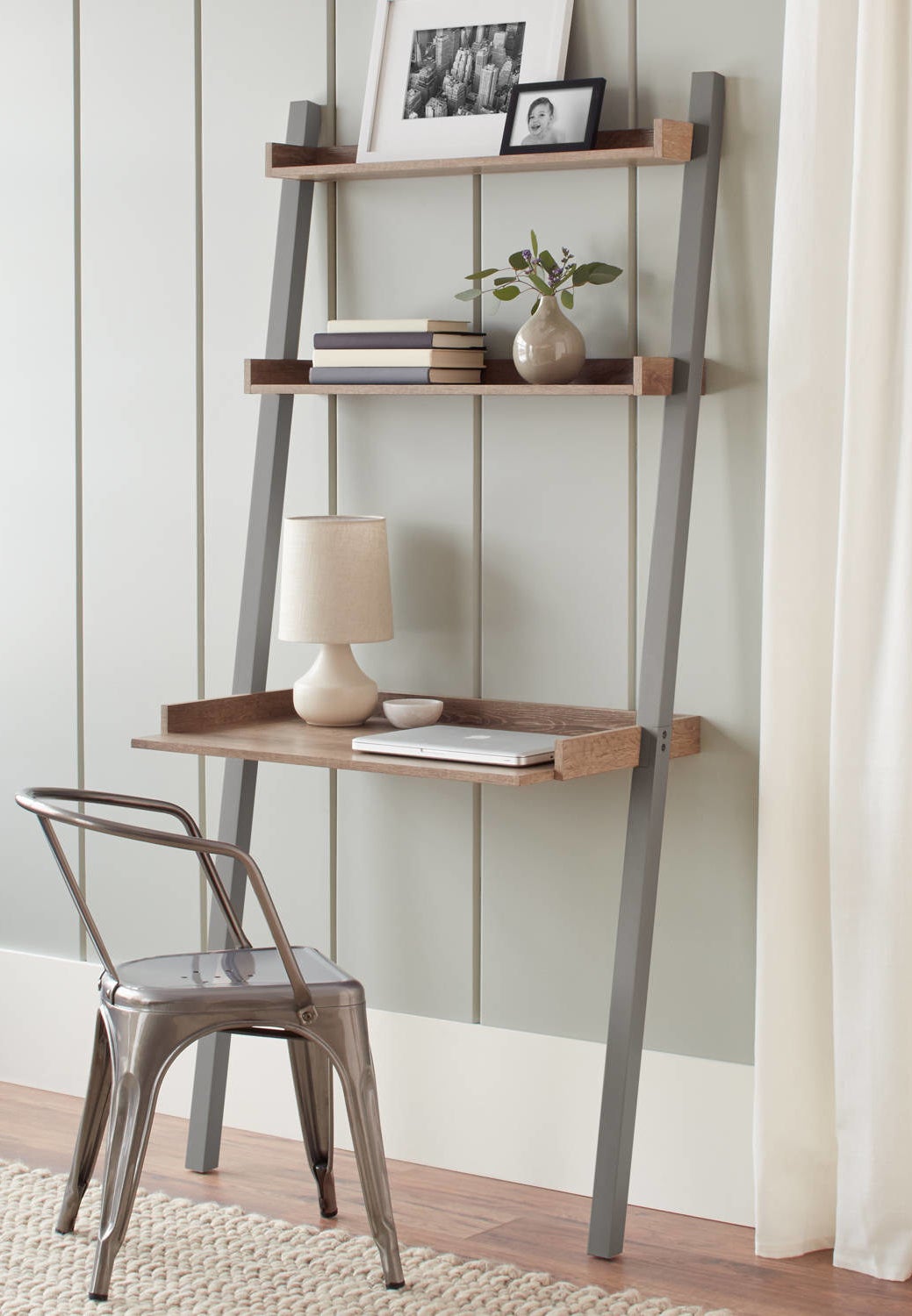 the gray brown leaning desk with three shelves