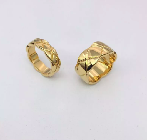 two gold tone rings with a criss cross design