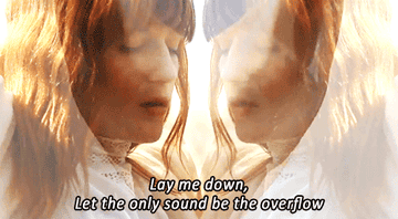 A clip of Florence Welch dancing with the lyrics lay me down let the only sound be the overflow on top