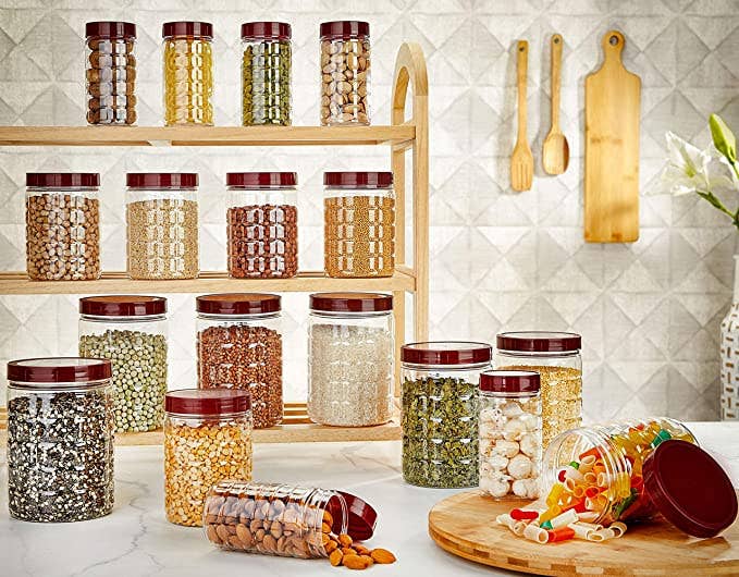 Transparent containers on a kitchen counter containing cuts, pulses, grains and cereals.