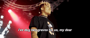 Gif of XXXTentacion on stage with the lyrics I&#x27;ve dug two graves for us my dear on top