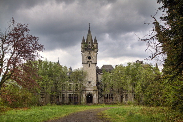 Gothic castle surrounded by trees with large central tower