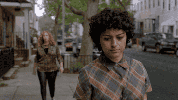 alia shawkat in &quot;search party&quot; looking over her shoulder on the street as someone&#x27;s following her