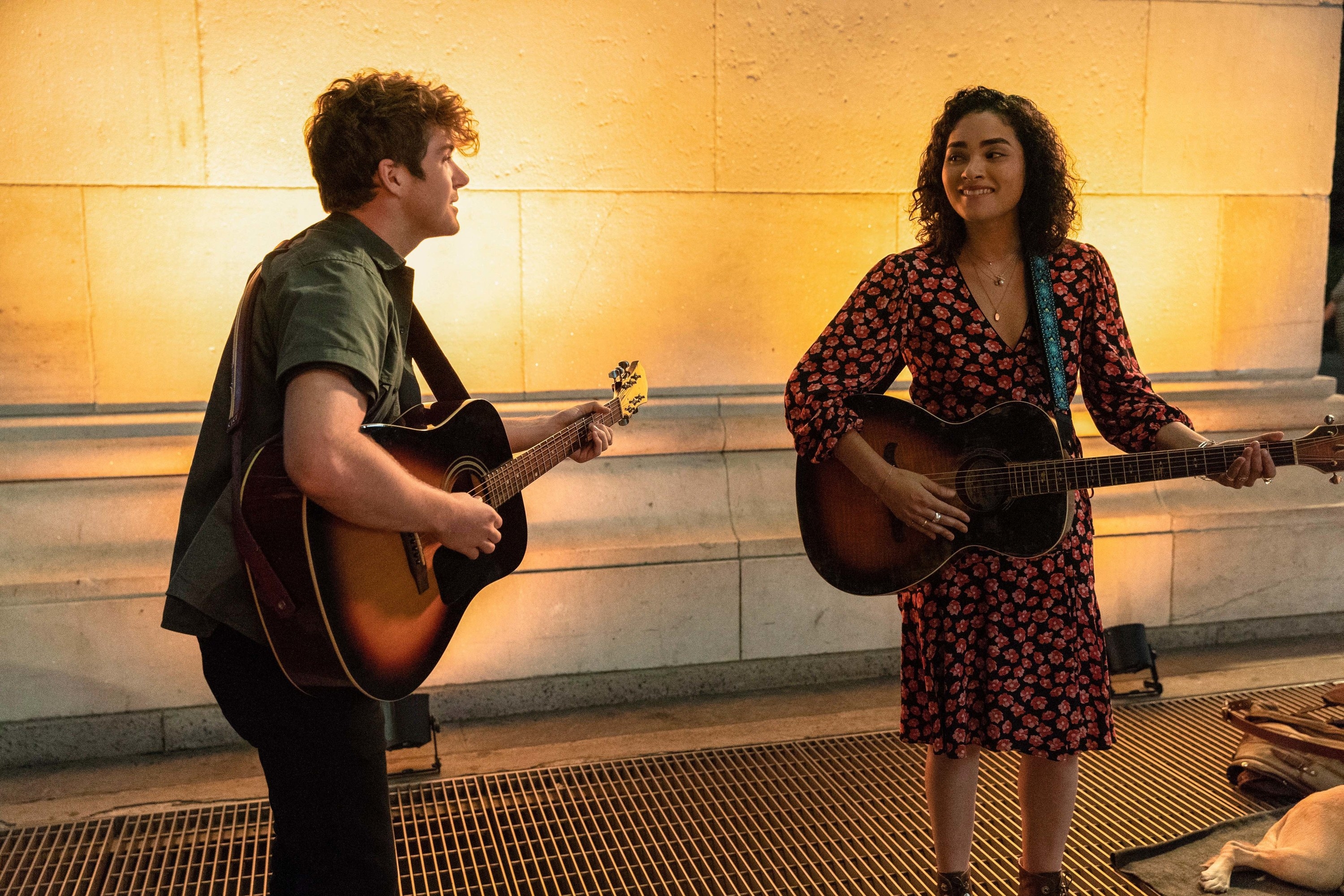 Colton Ryan and Brittany O’Grady as Samuel and Bess singing and playing guitar together