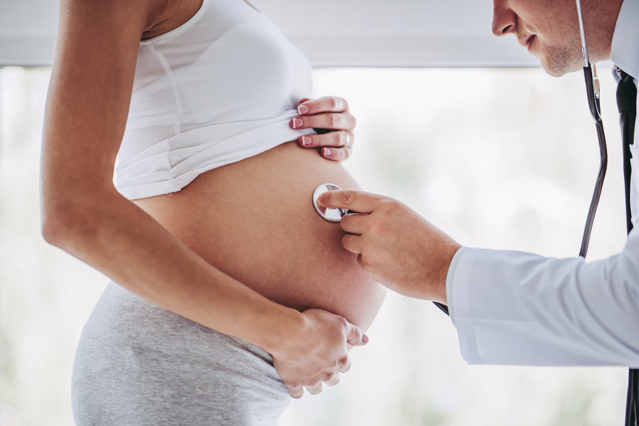 Doctor checking on a pregnant woman&#x27;s stomach