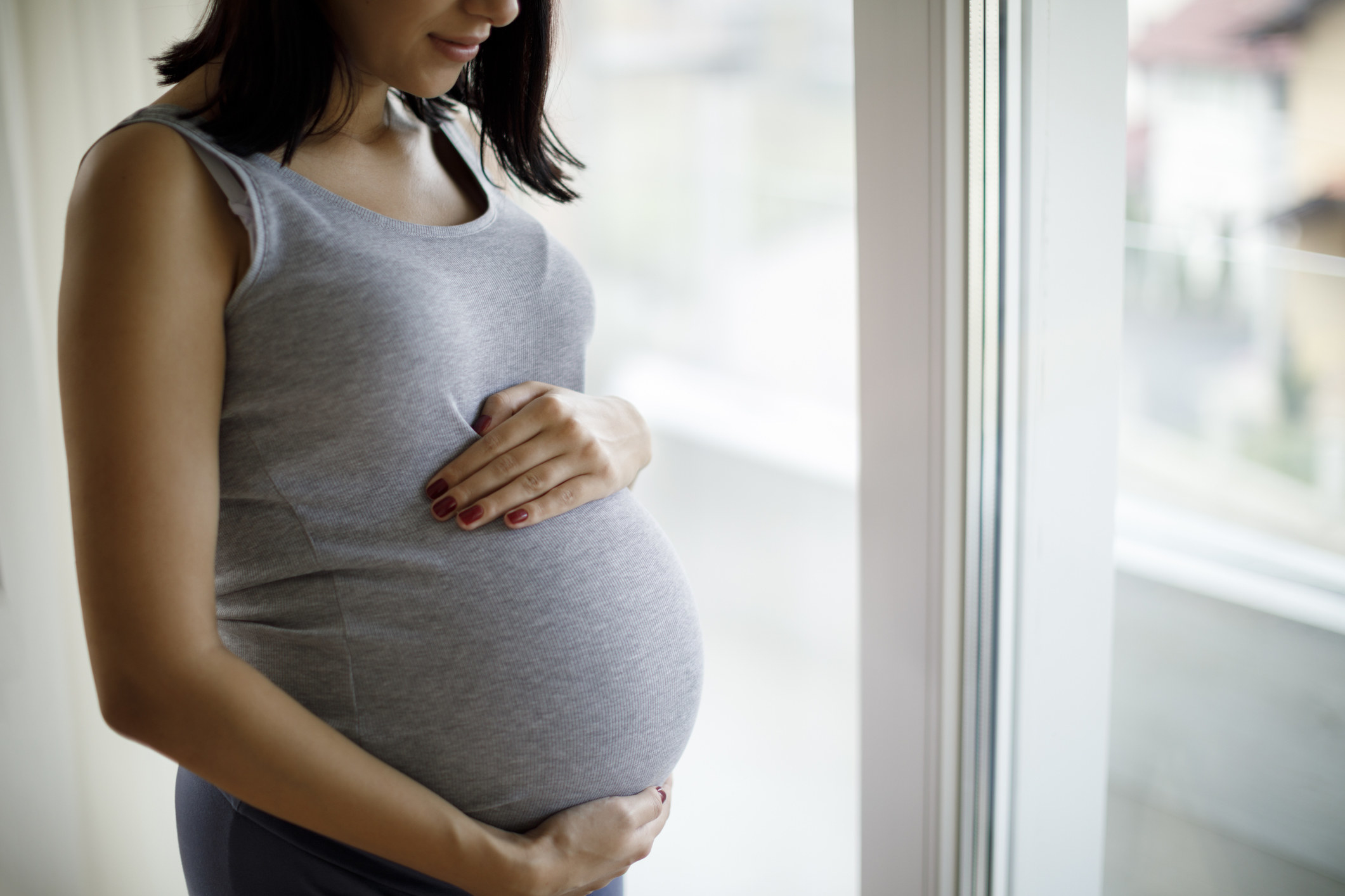 Pregnant woman holding her belly