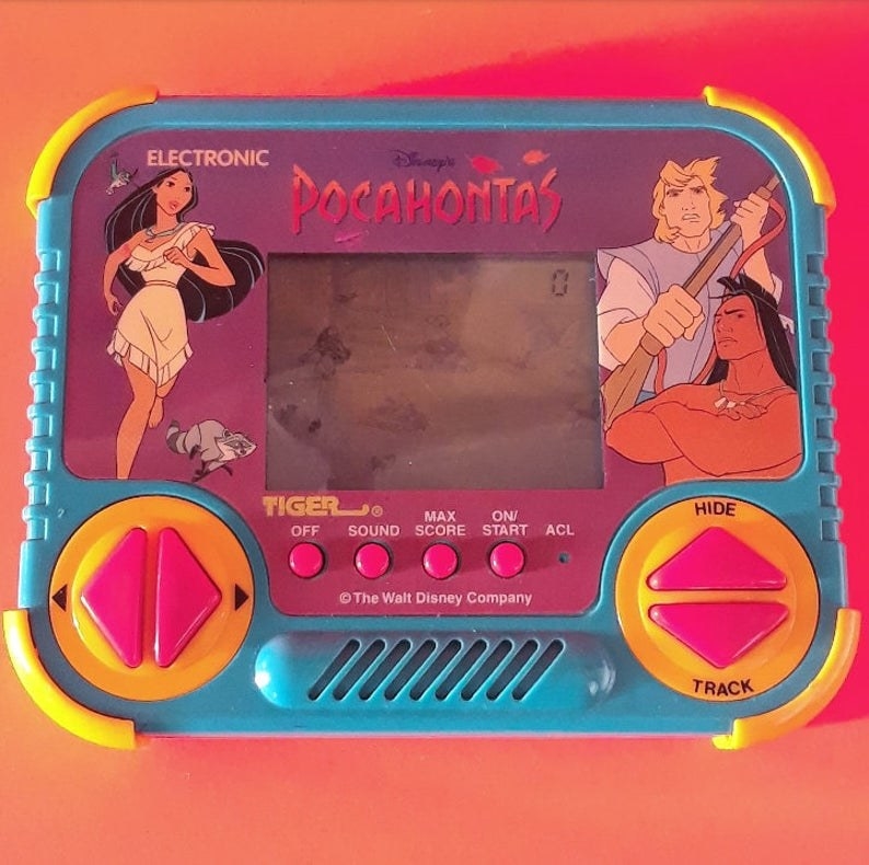 A close-up of the Pocahontas Tiger Electronics handheld game, which is in pink, purple and blue.