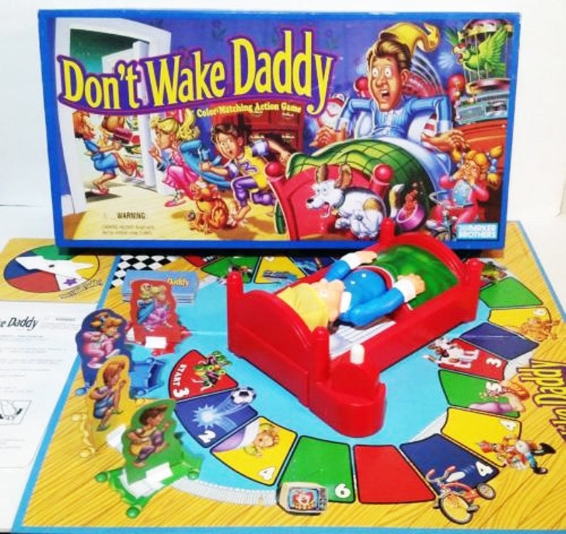 The Don&#x27;t Wake Daddy board game set up with the box for it behind it.