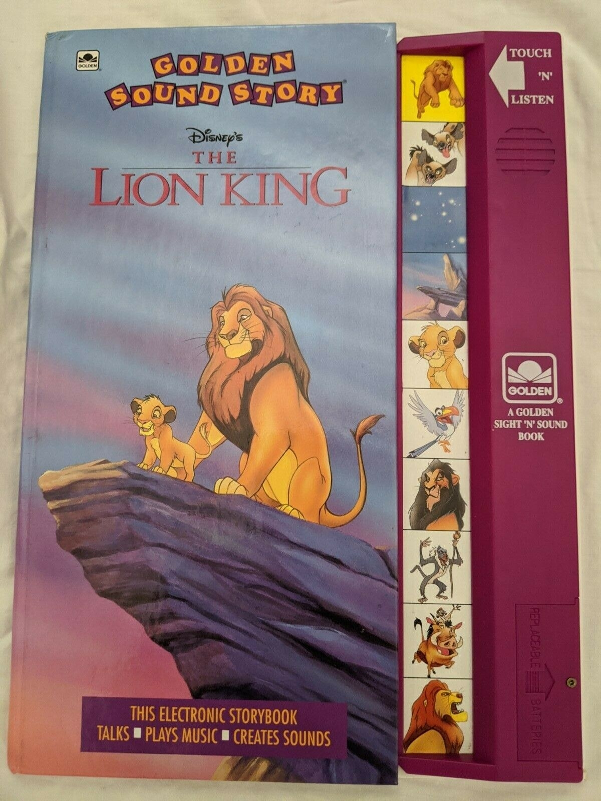 A photo of a Lion King Disney Golden Sound Story book, which has a purple touch pad with the characters faces on it.