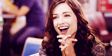 Allison Argent looking on happily with a big grin