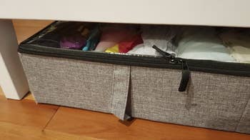 the same storage case slide underneath the bed with extra room between the bed's bottom and the case
