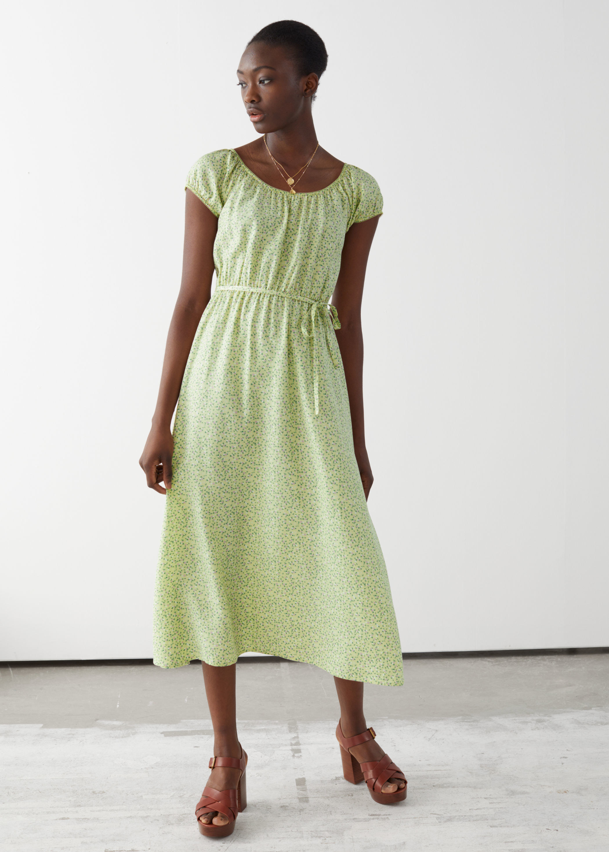 model wearing green floral midi dress