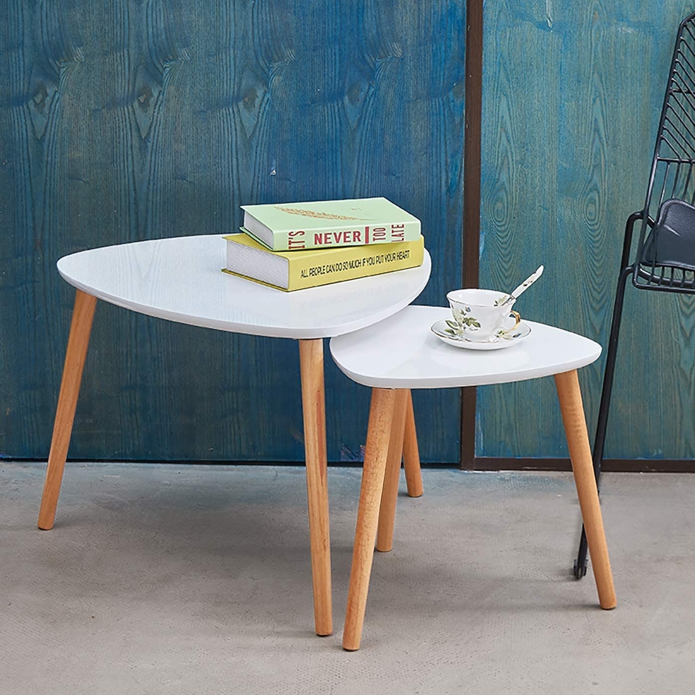 The two side tables in medium and small sizes with wooden legs and white surfaces