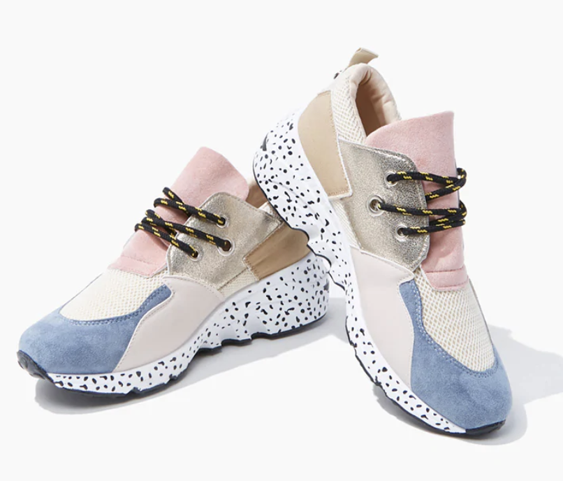 The shoes, which have white soles with black dots, and colorblocked blue, pink, beige, and ivory on top 